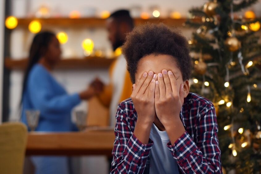 Sad,,Desperate,Little,Boy,Closing,Eyes,During,Parents,Quarrel,On